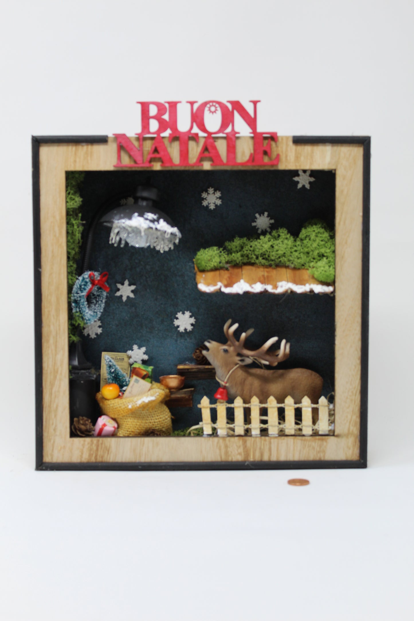 cornice con renna e scritta "buon natale"