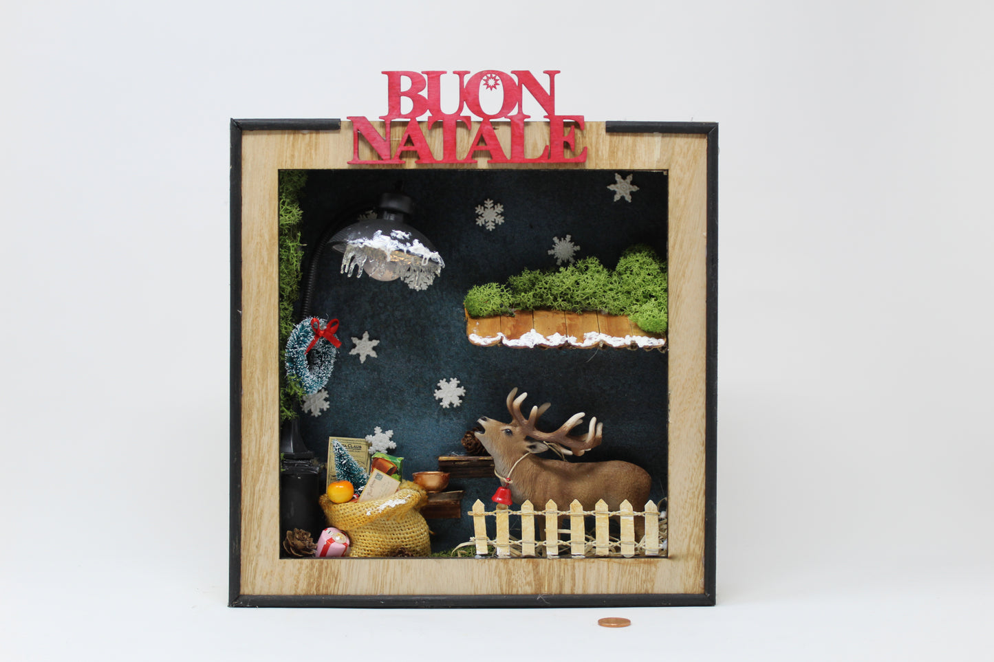 cornice con renna e scritta "buon natale"